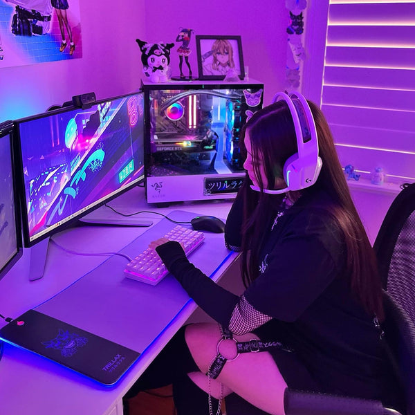 Relaxing scene: A girl sits at her desk, immersed in a tranquil atmosphere created by the soothing lavender lights emanating from the Lavender RGB mousepad, adding a serene ambiance to her space.